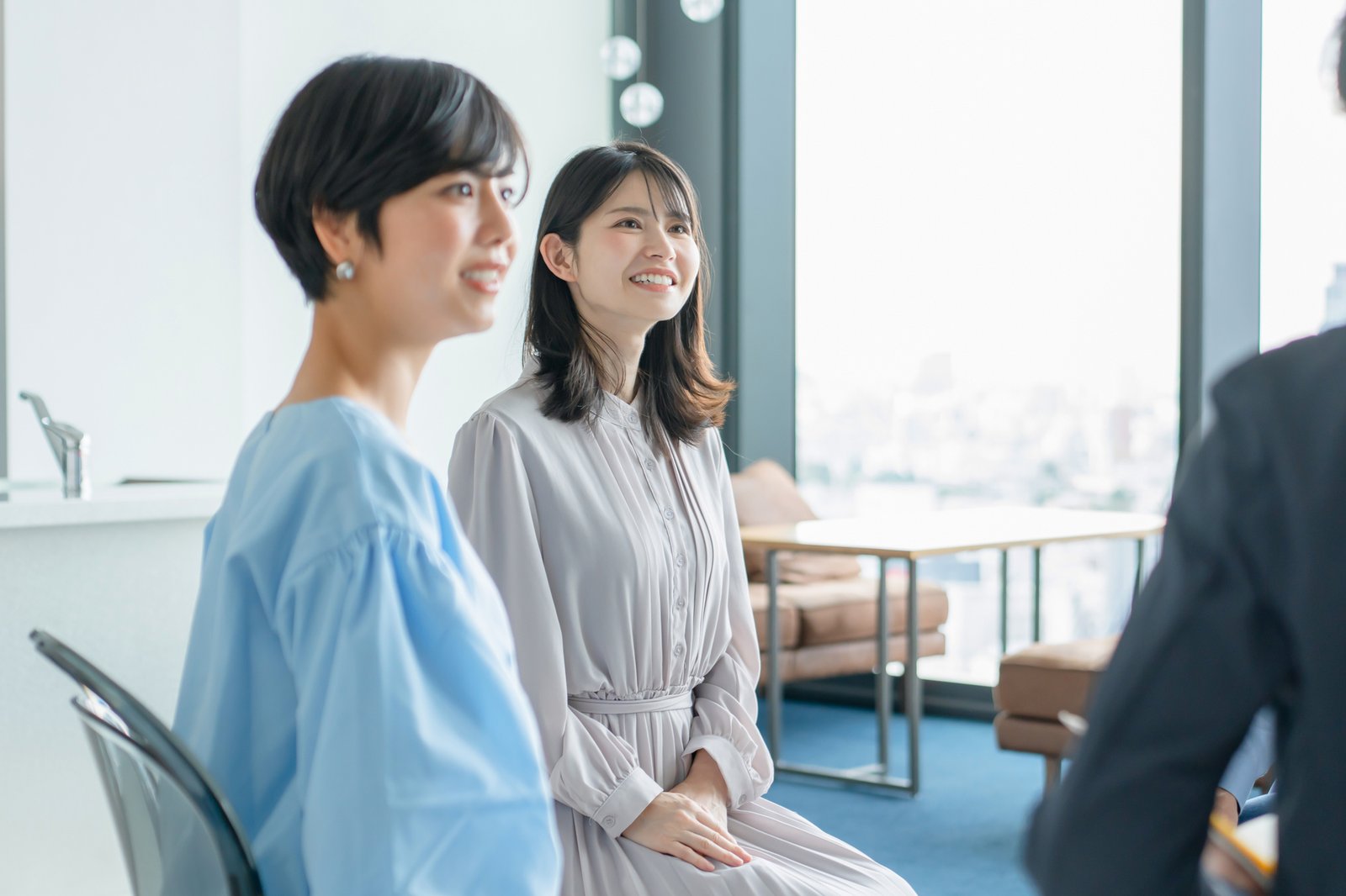 明るい部屋で話を聞く女性たち